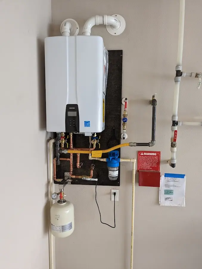 Professional plumber installing copper piping in a Ingram home